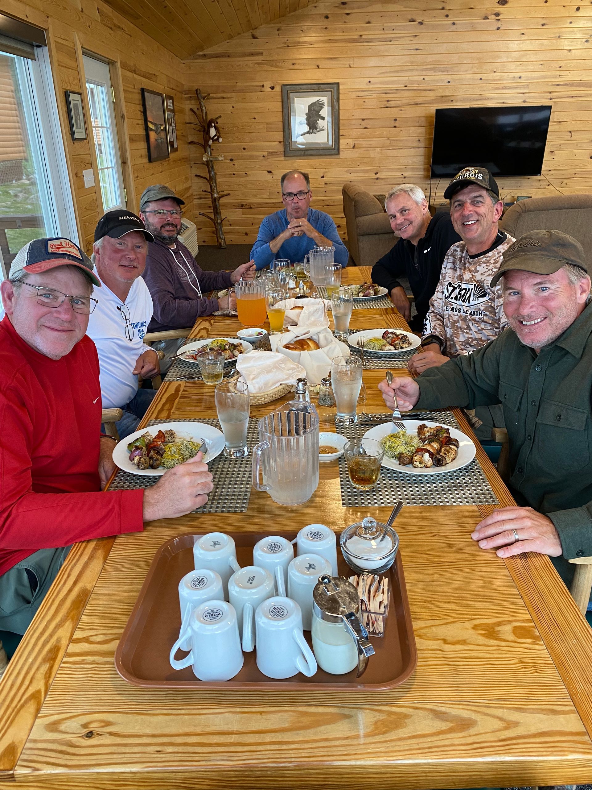 A group of friends dining at Oak Lake Lodge's American Plan Fly-in fishing lodge in Ontario, Canada.