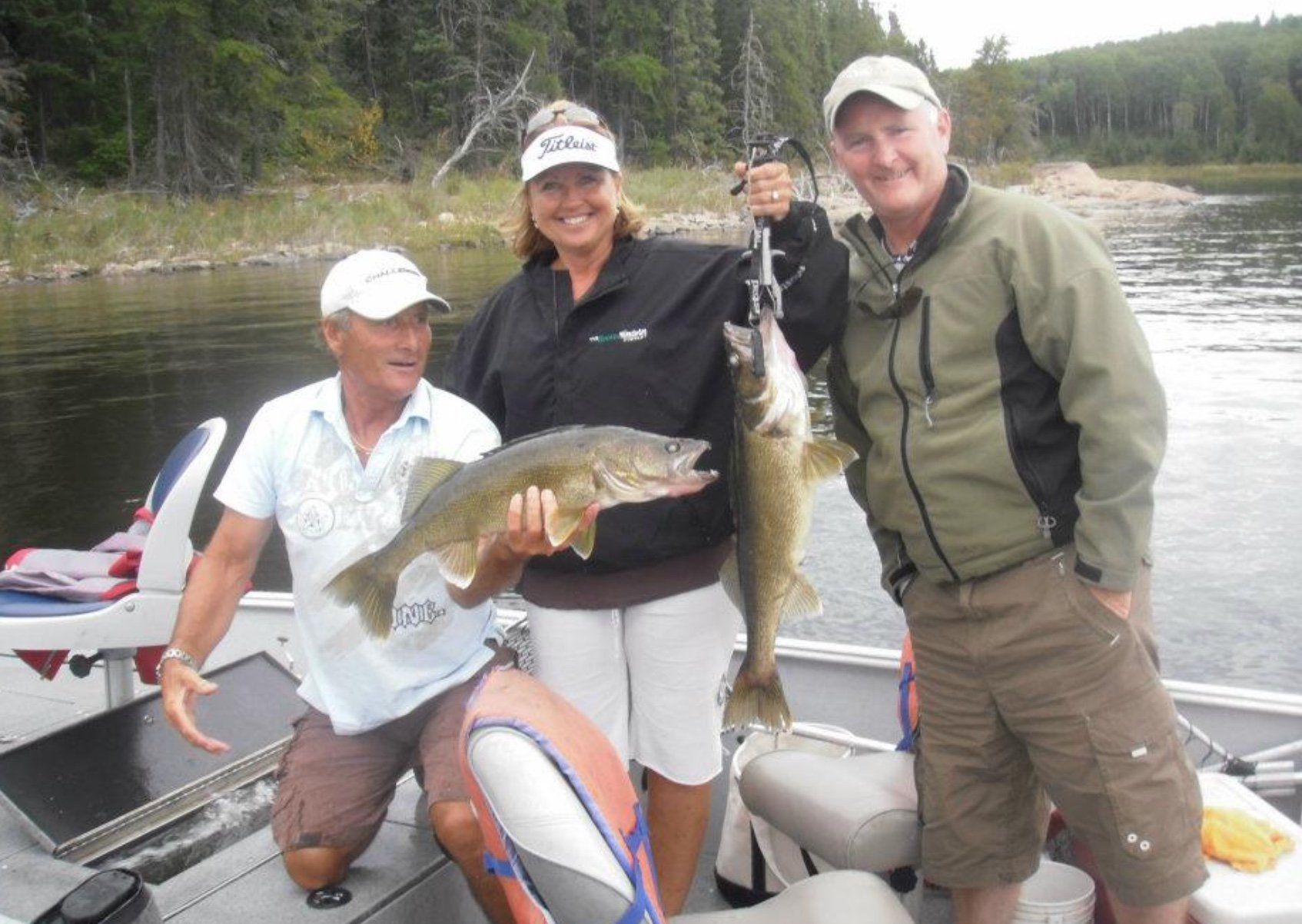 Ernie holding a walleye for his fishing guests.