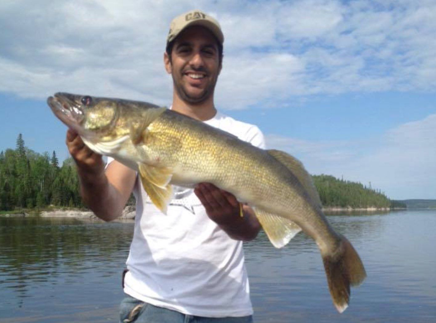 David holding up his walleye in the summer sun.