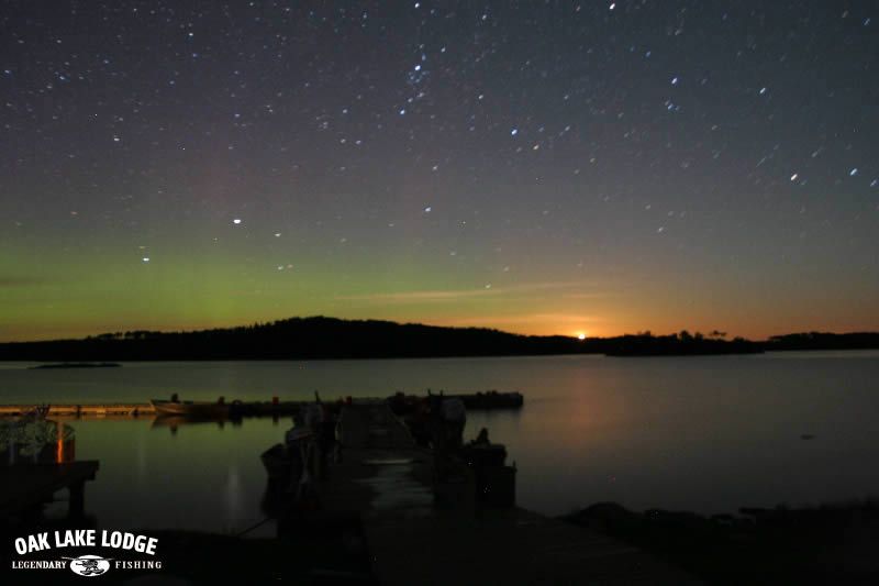A picture of a lake with the words oak lake lodge on the bottom