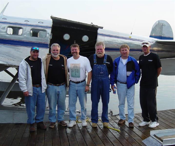 September fly-in fishing trip. Group of men on dock.