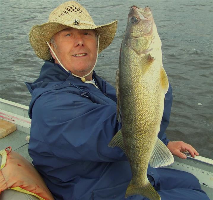Fisherman holding a walleye in Canada