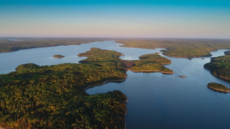 An aerial view of a large lake surrounded by trees.