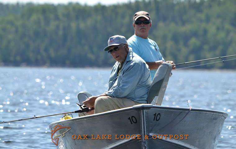 Lund boat with two men fishing, sitting on swivel seats.