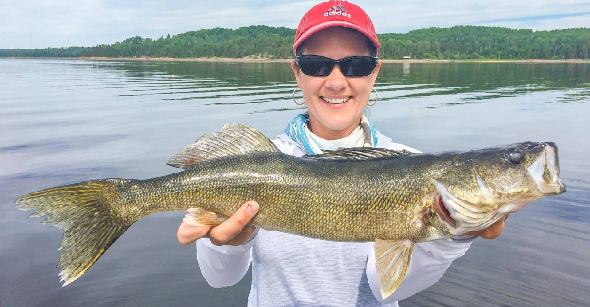 Walleye caught by women in red hat at Oak Lake Lodge.