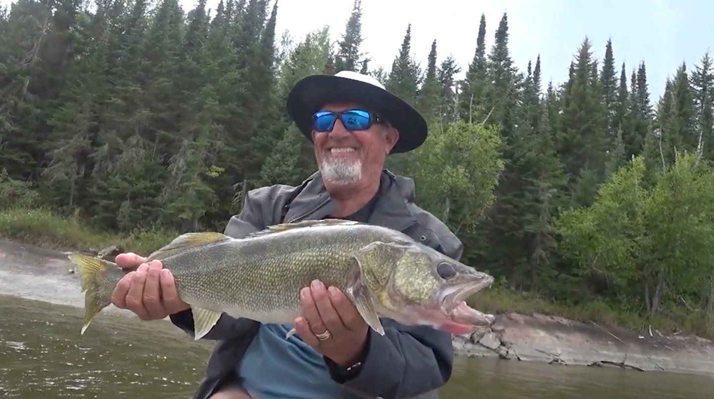 Fisherman with a walleye caught on a fly-in fishing trip to Canada.