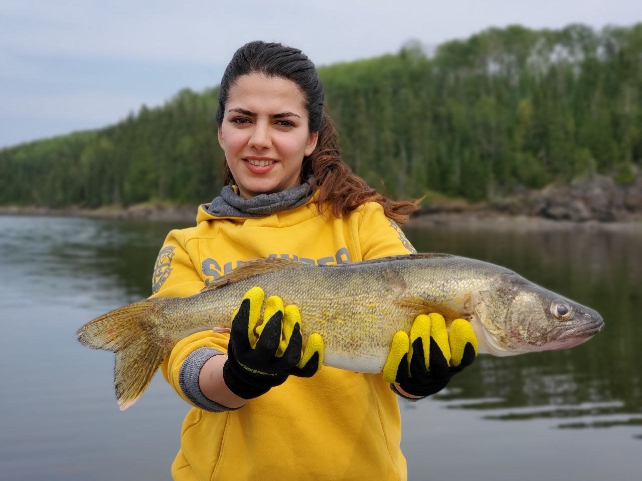 Young woman holding up the walleye she caught at Oak Lake.