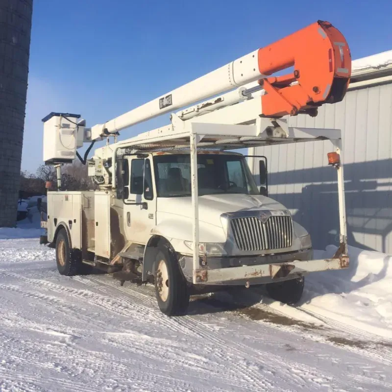 A white truck with an orange crane on top of it