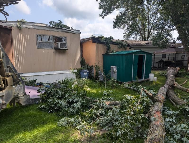 A mobile home with a green shed in front of it