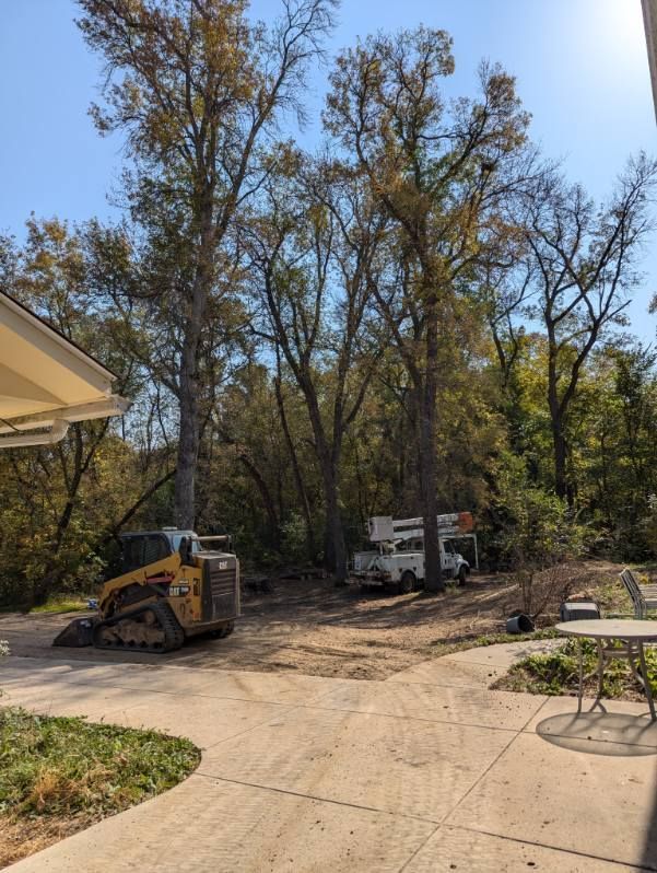 A bulldozer is parked in a driveway in front of a house.