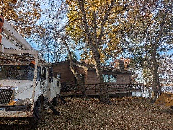 A white truck is parked in front of a house.