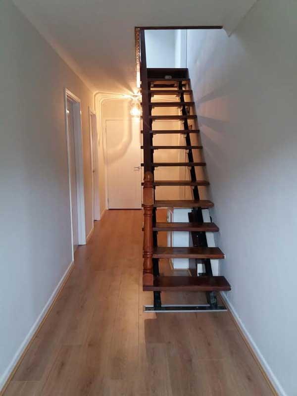 Clean-looking hallway, minimalist, wooden floors and staircase
