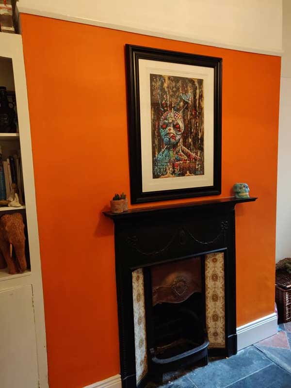 Terracotta painted wall, dark wood fire surround