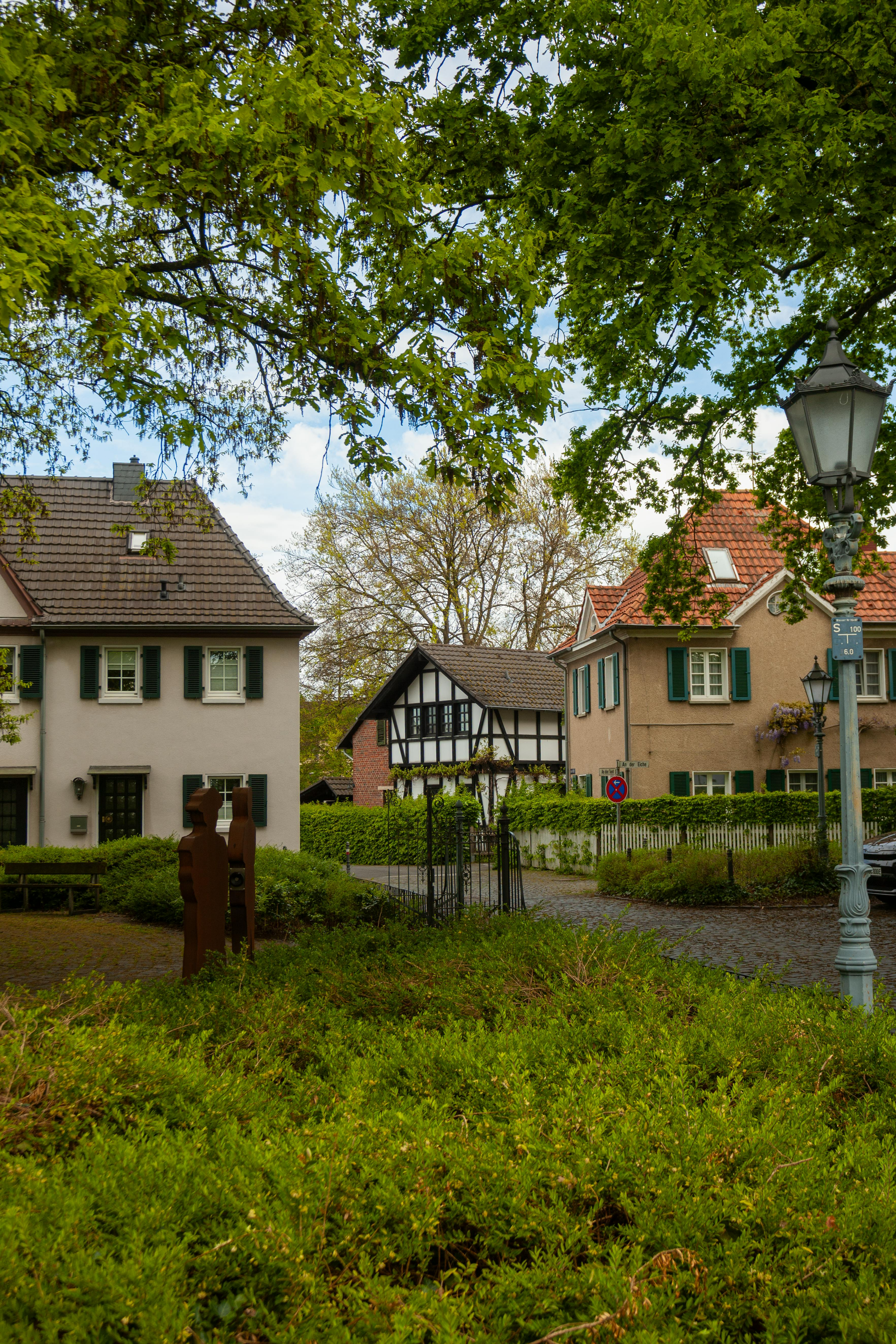 A dining room with a table and chairs and a wooden staircase.
