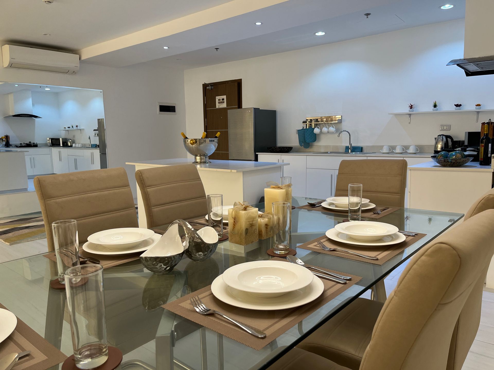 A dining room table with plates and glasses on it