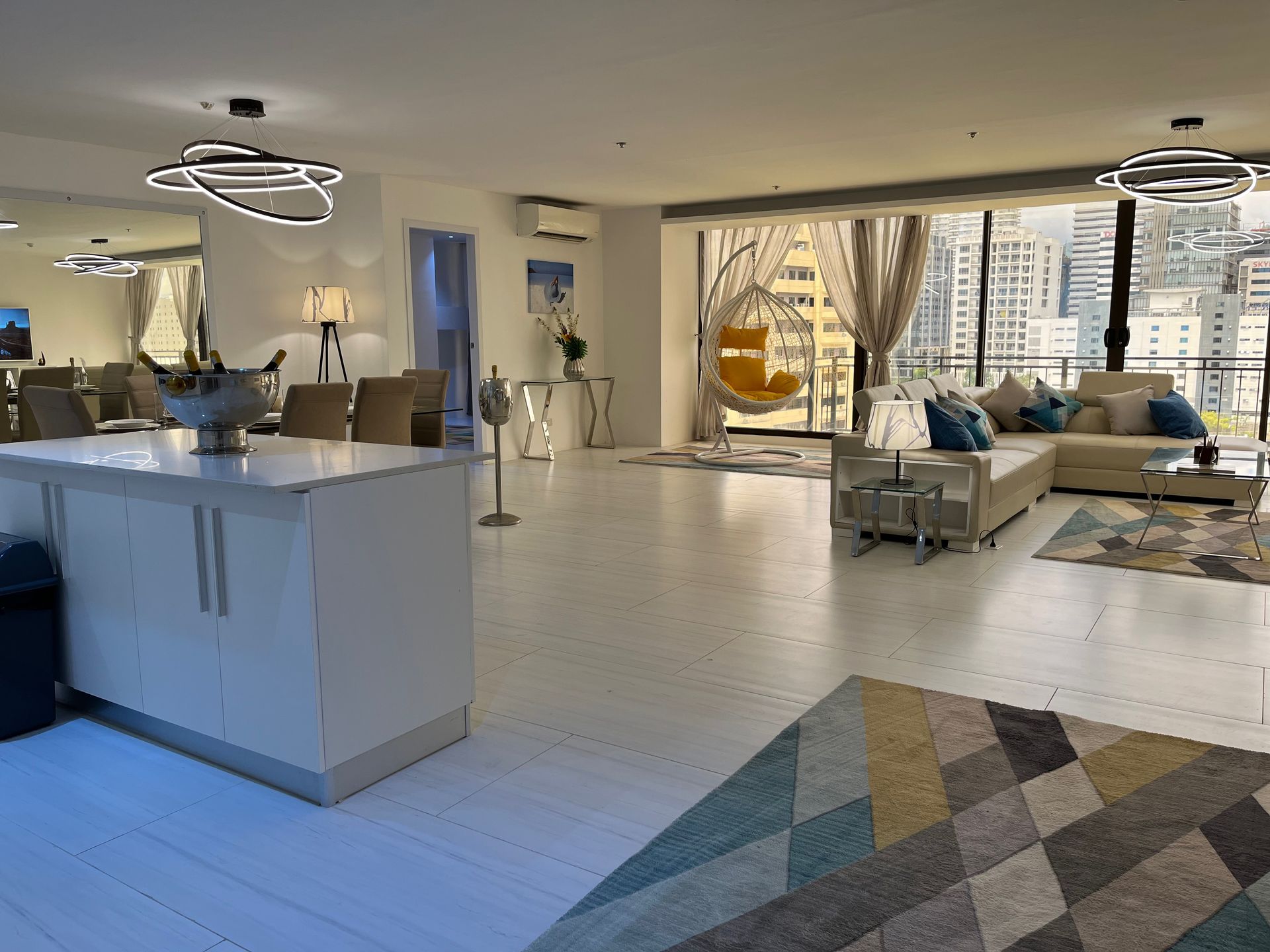 A living room filled with furniture and a rug.