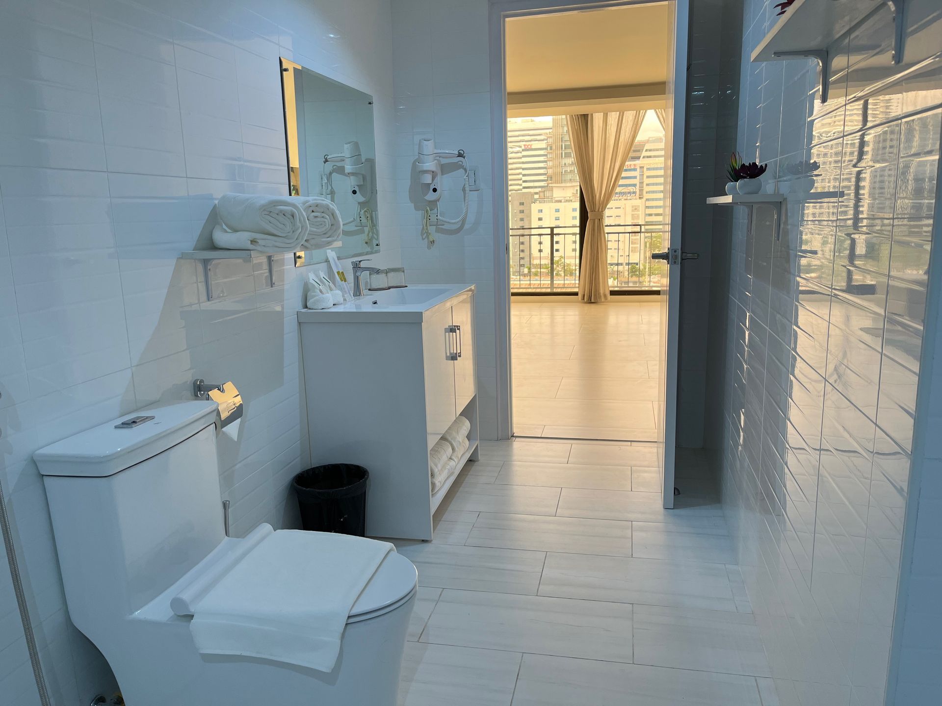 A bathroom with a toilet a sink and a mirror