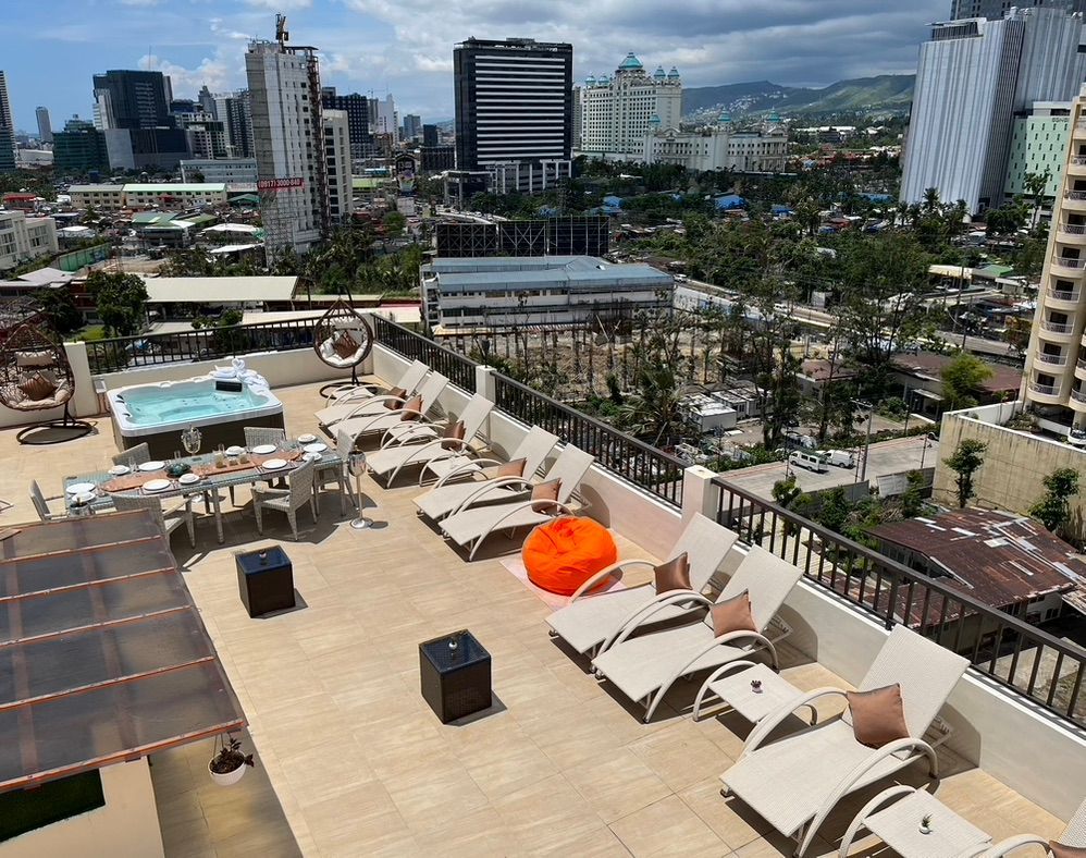 An aerial view of a rooftop with a pool and chairs