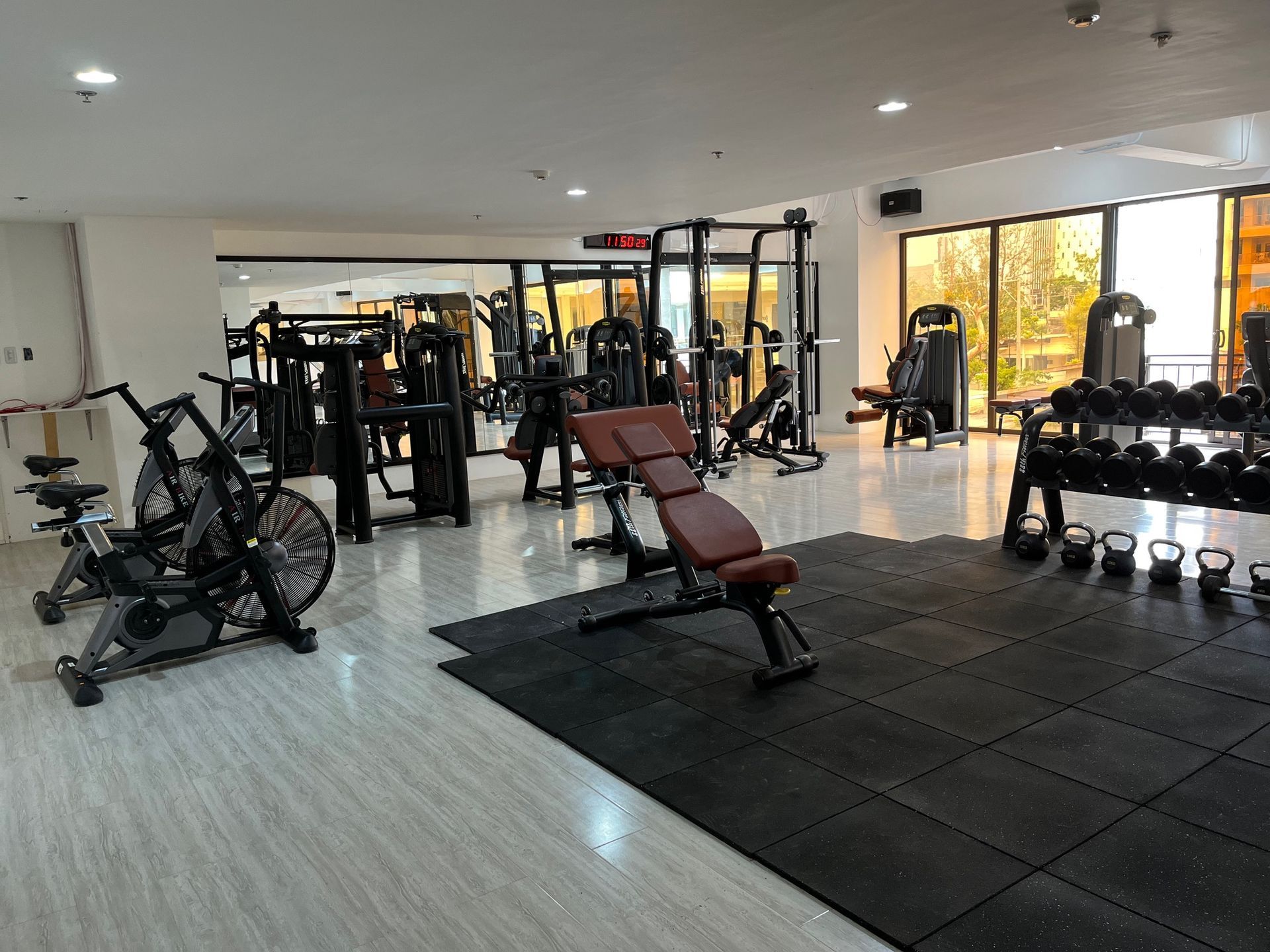 A large gym filled with lots of exercise equipment.