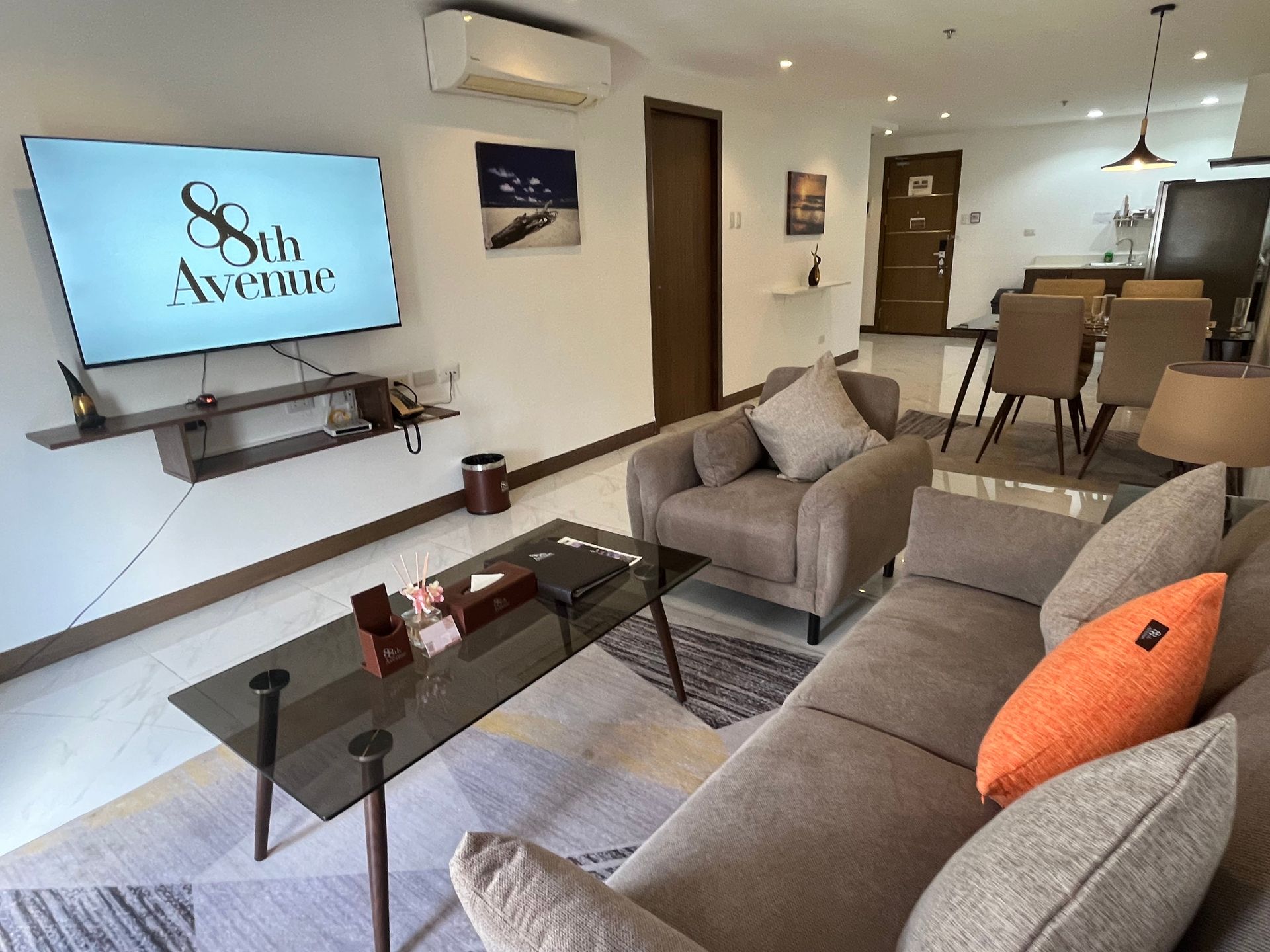 A living room with a dining table and chairs and a couch.