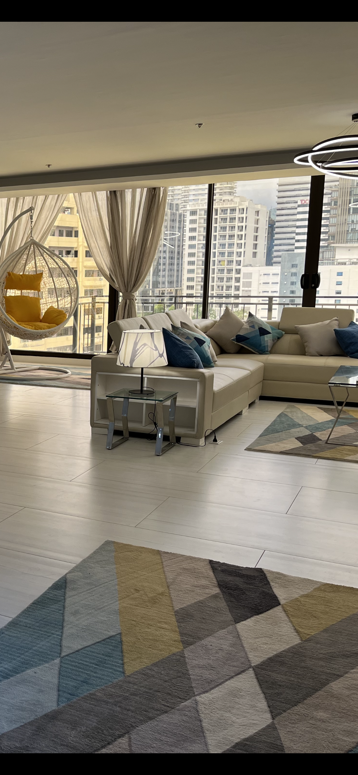 A living room filled with furniture and a rug.