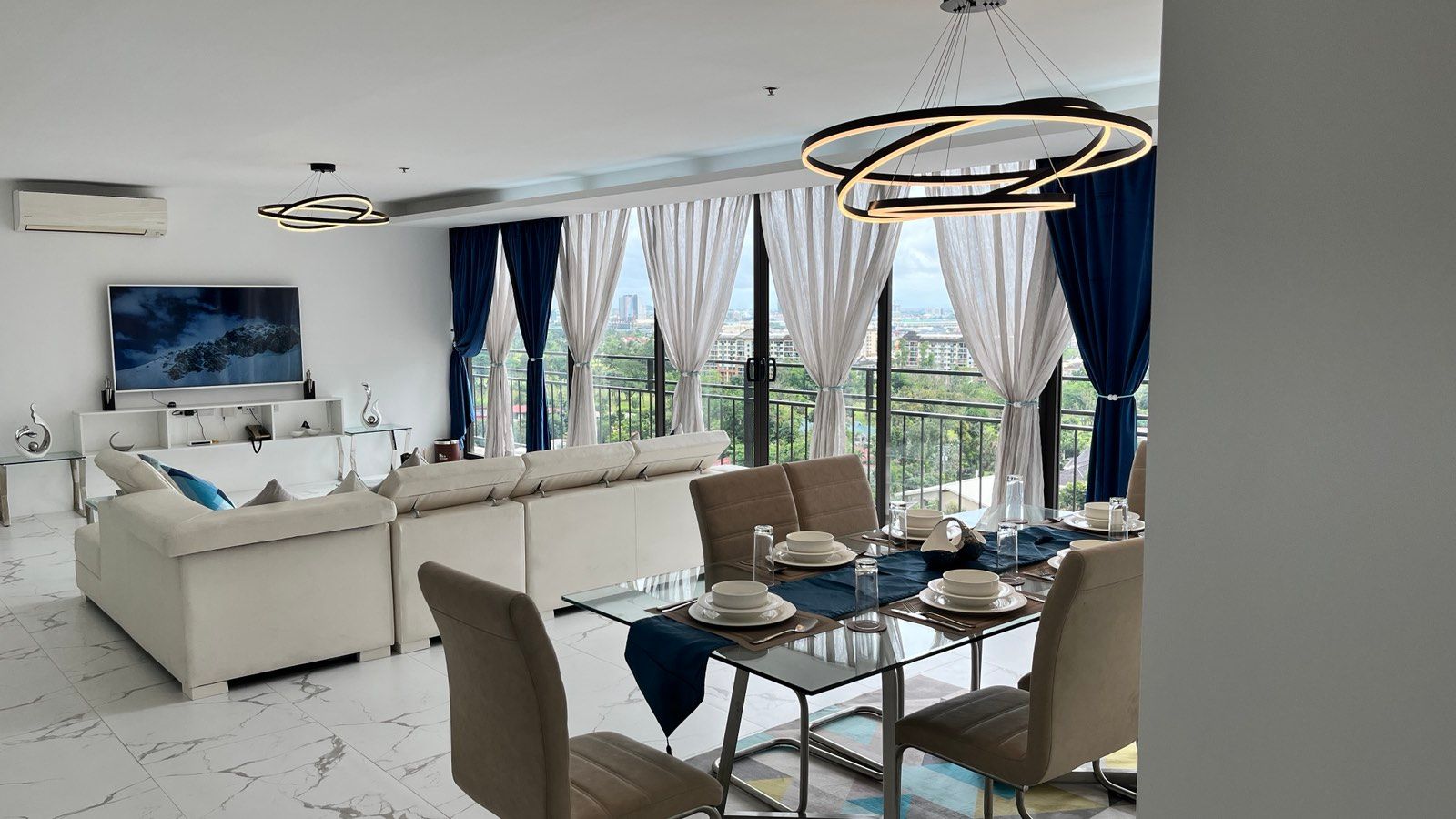 A living room with a dining table and chairs and a couch.