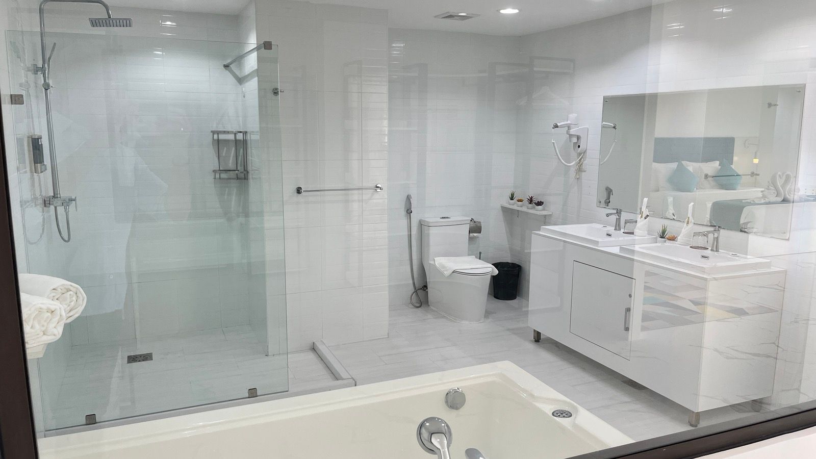 A bathroom with a tub , sink , toilet and shower.