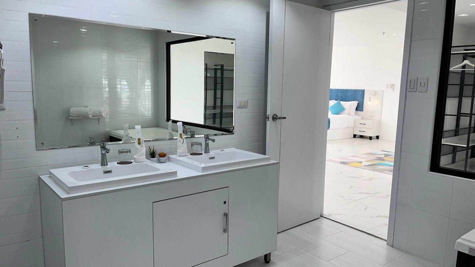 A bathroom with two sinks and a large mirror.