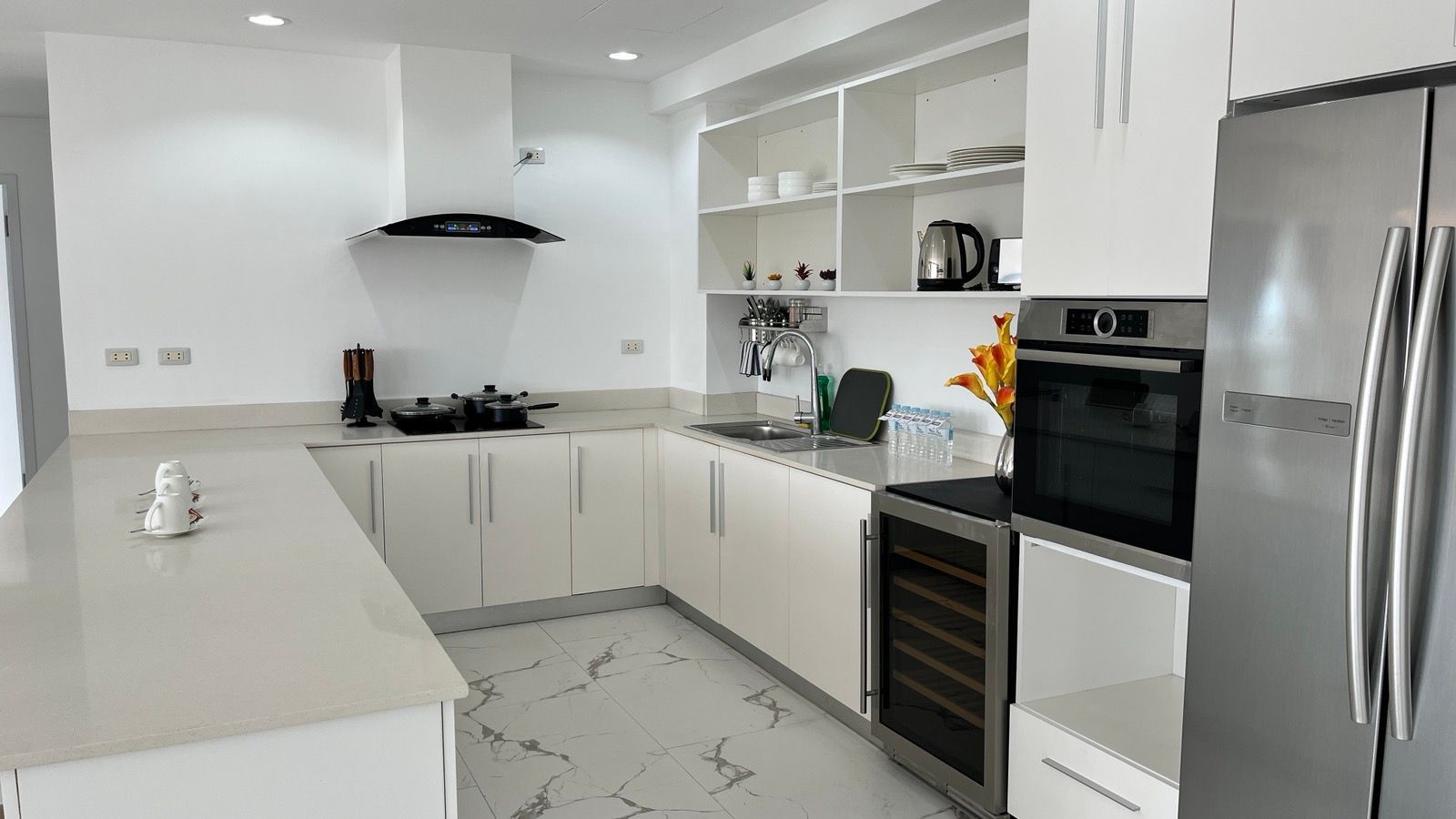 A kitchen with white cabinets and stainless steel appliances.