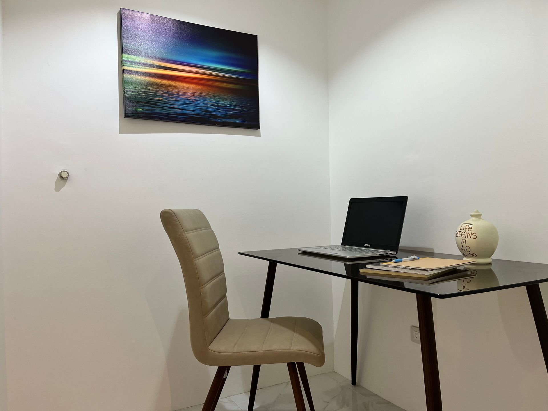 A chair is sitting at a desk with a laptop on it.