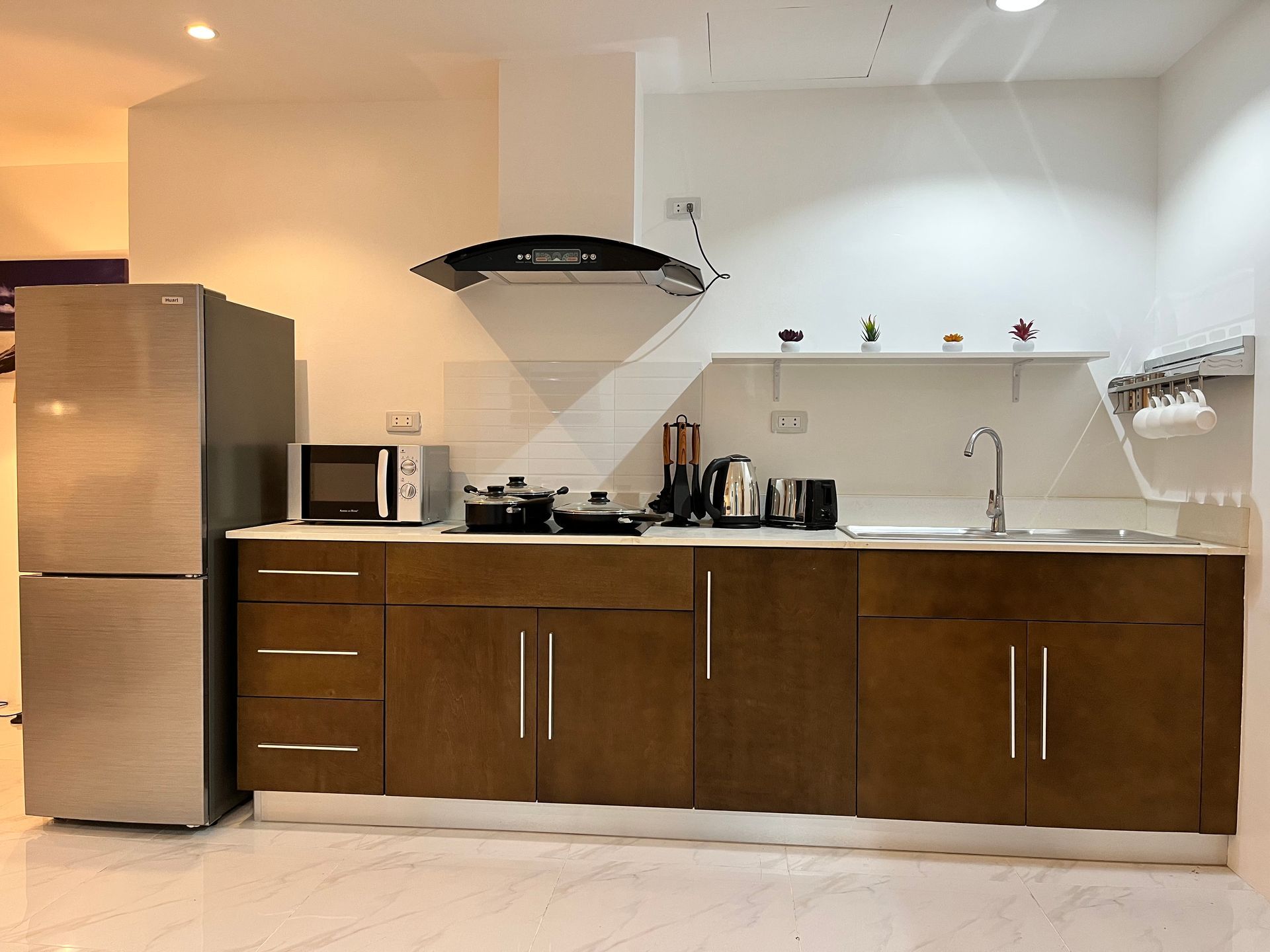 A kitchen with stainless steel appliances and wooden cabinets