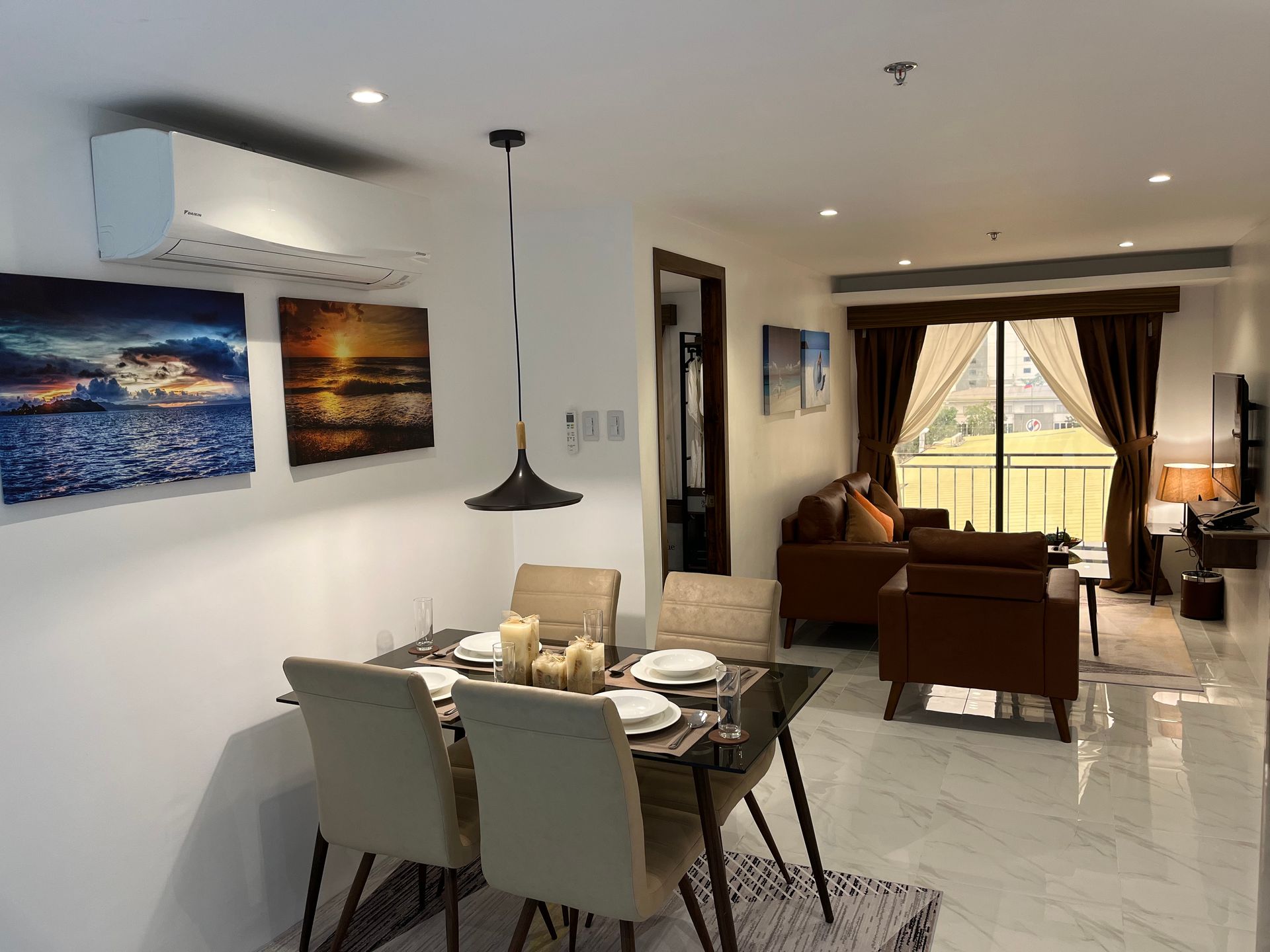 A living room with a dining table and chairs and a couch.