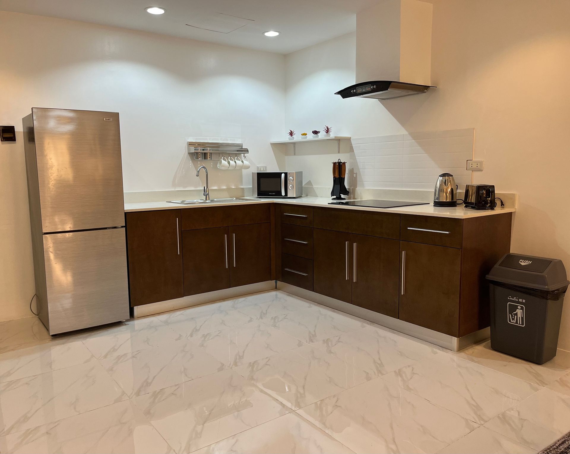 A kitchen with stainless steel appliances and wooden cabinets