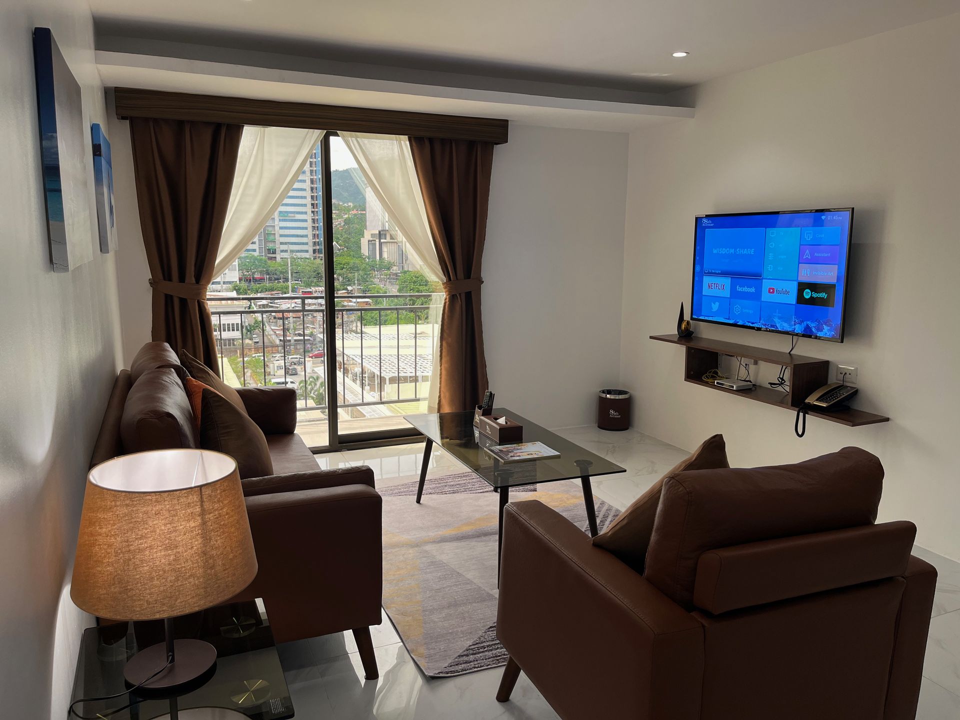 A living room with a couch , chair , table and television.