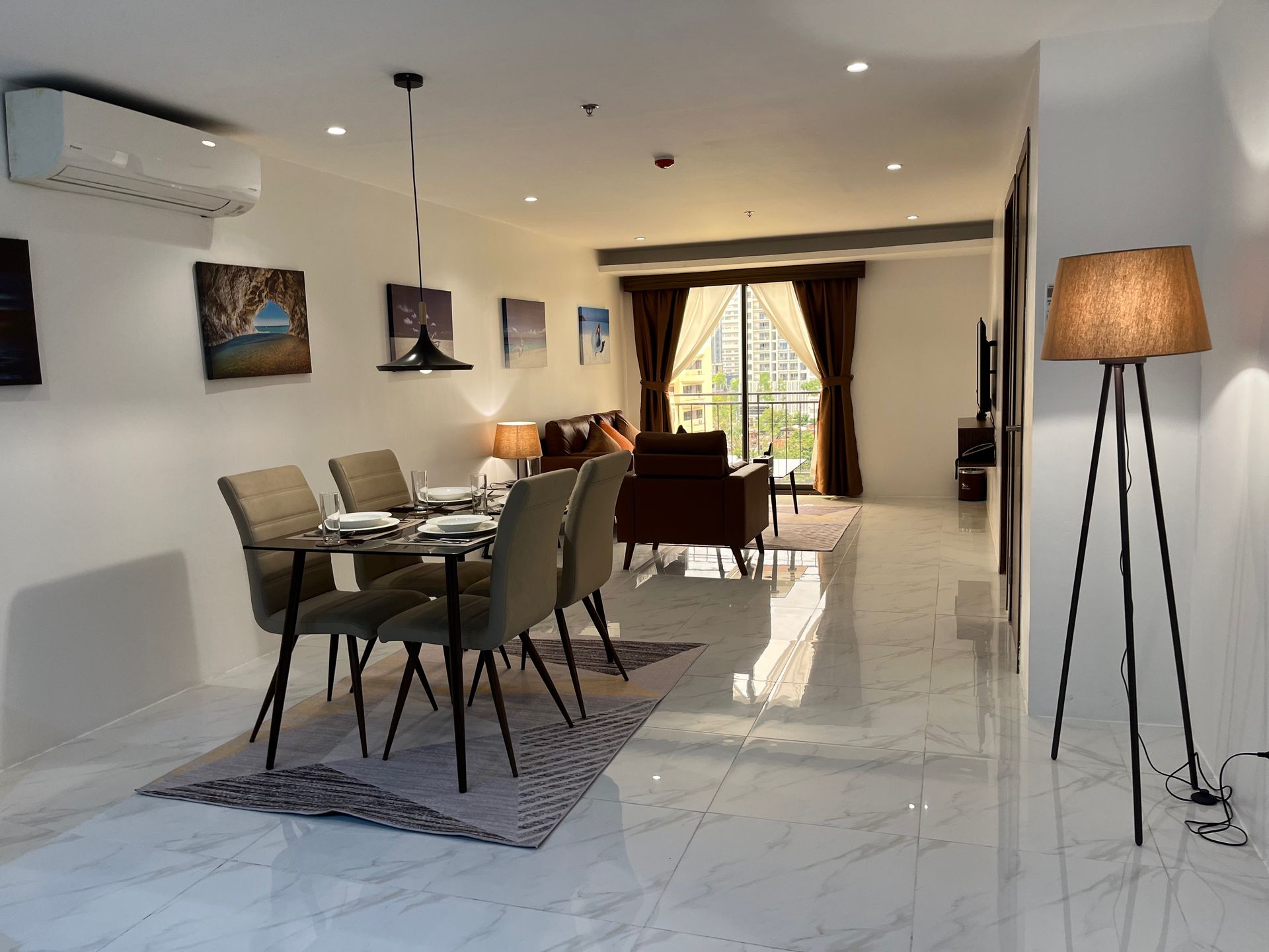 A living room with a table and chairs and a lamp