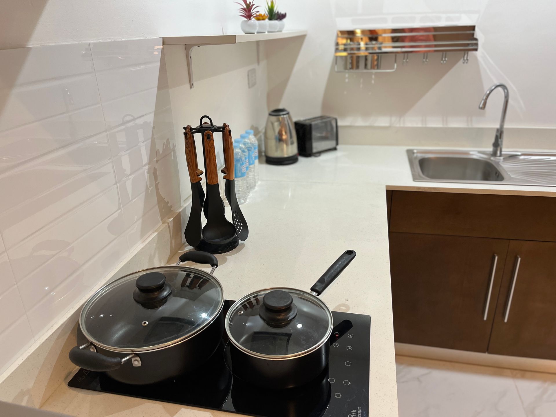 Two pots and pans are sitting on a stove in a kitchen.