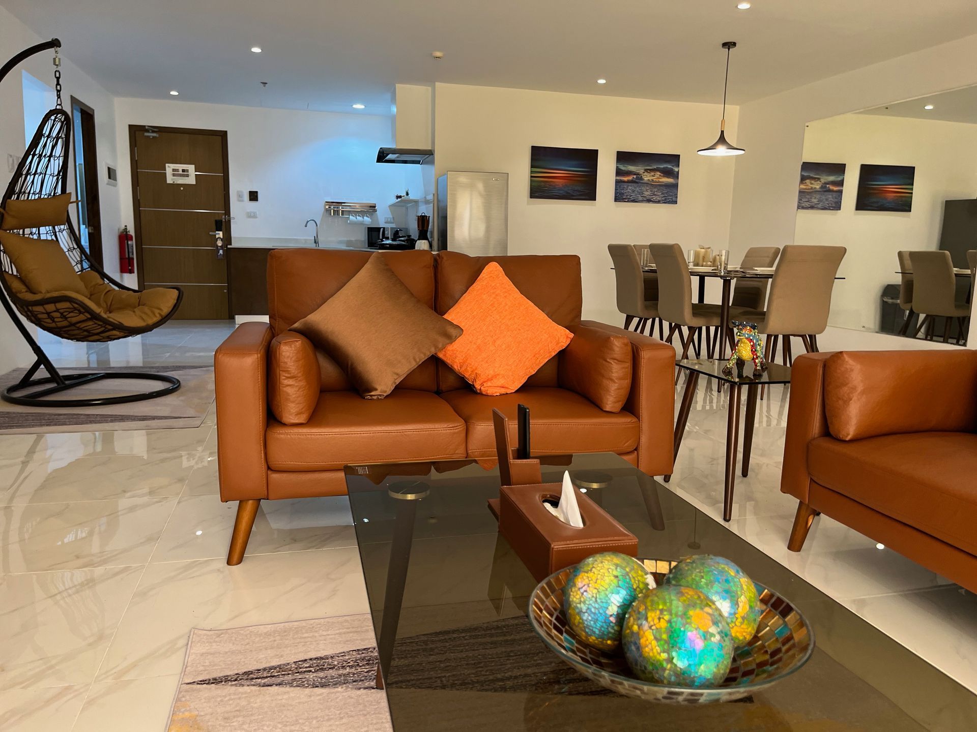 A living room with a couch , chair , table and globe on the table.