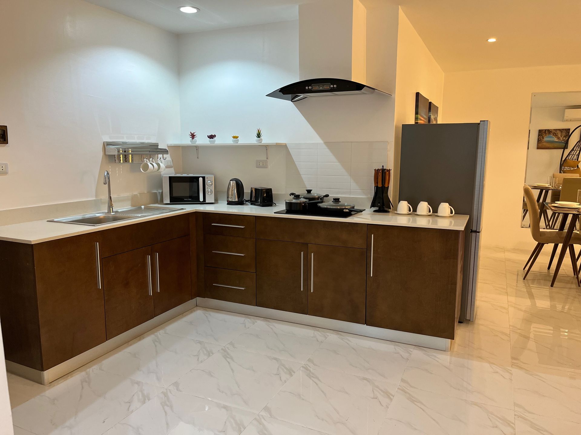 A kitchen with wooden cabinets and white counter tops