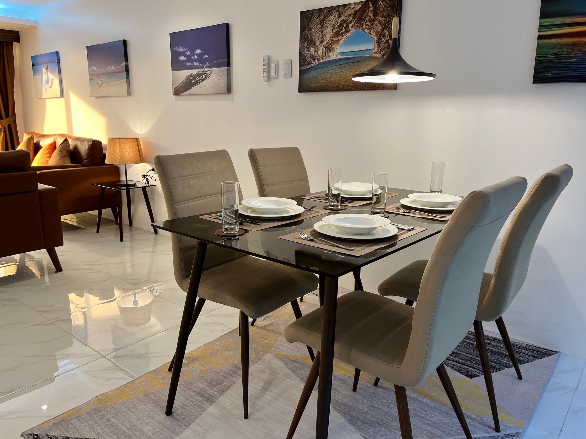 A dining room table with four chairs and plates on it.