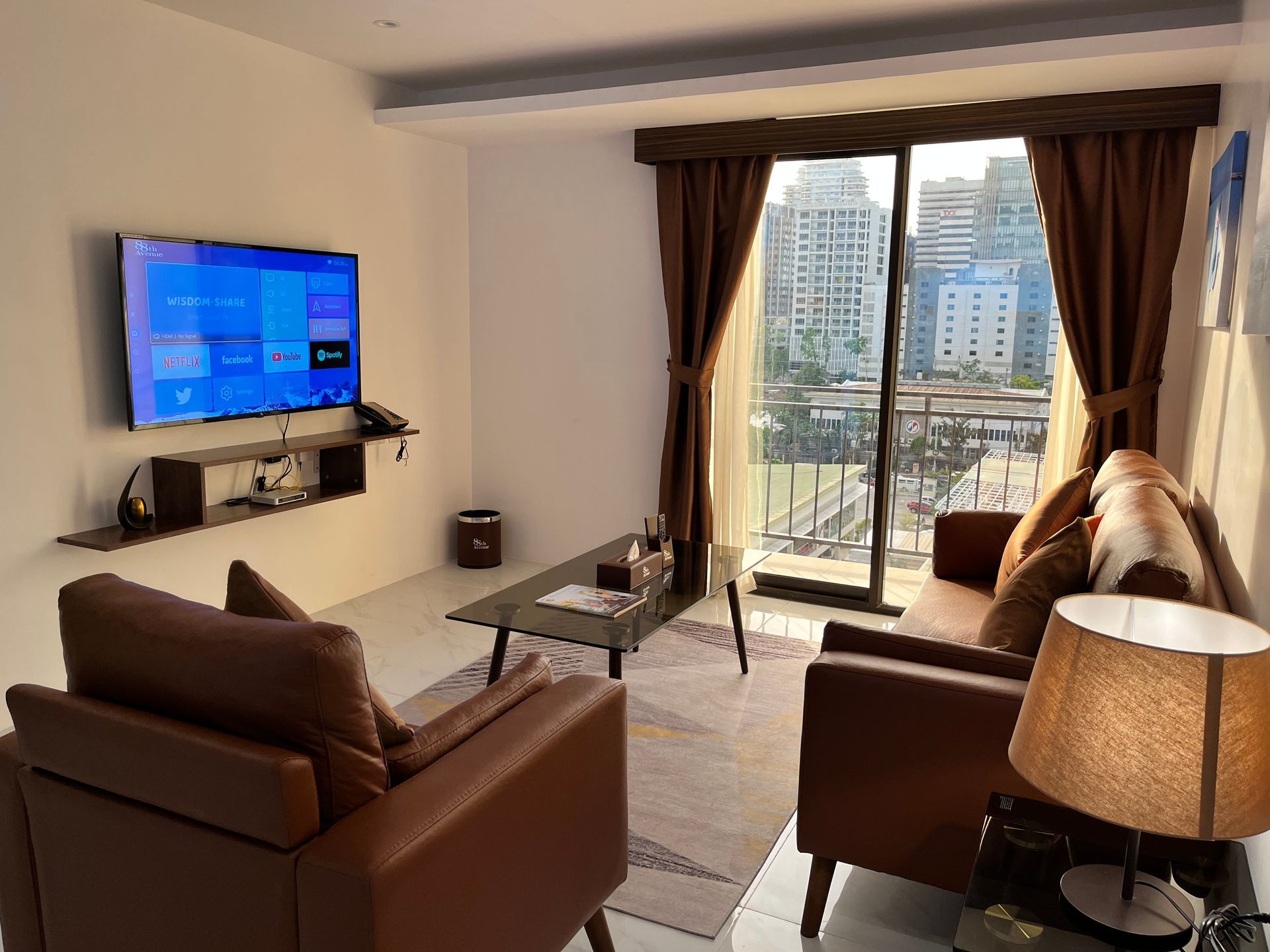 A living room with a couch , chair , table and television.