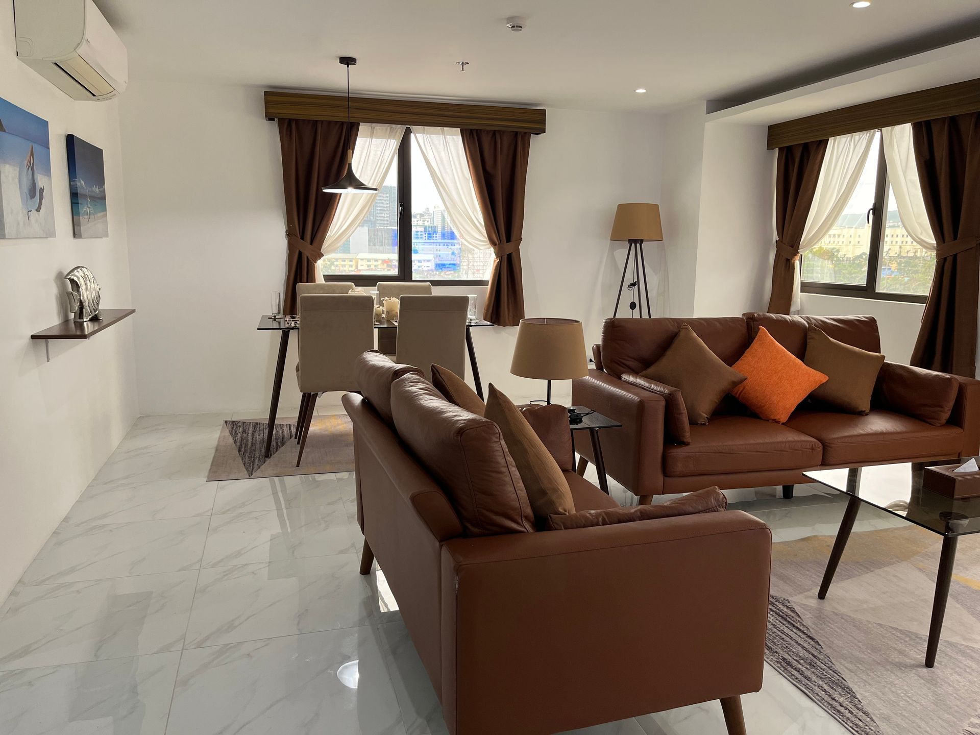 A living room with a brown couch and a table