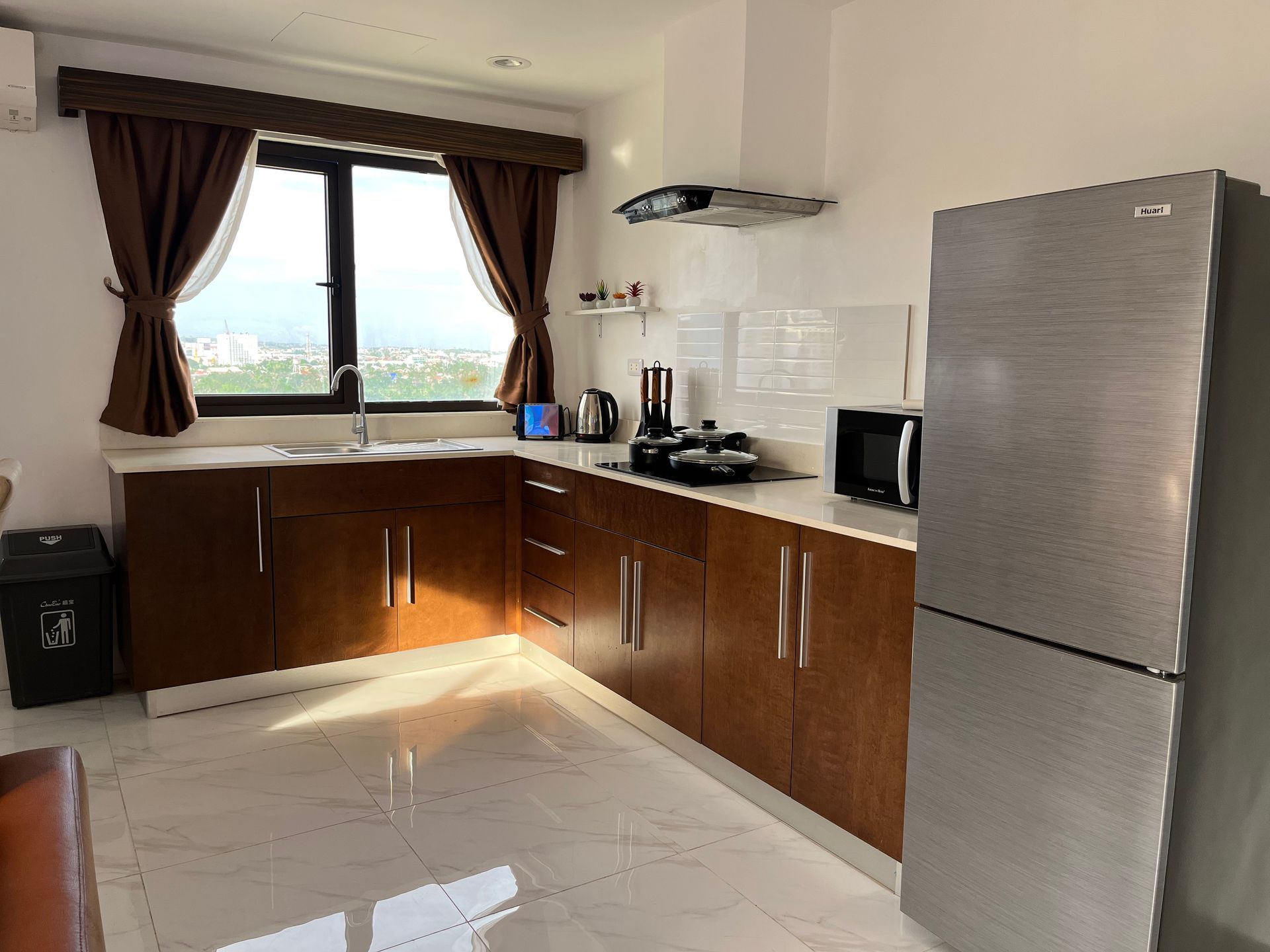 A kitchen with stainless steel appliances and wooden cabinets.