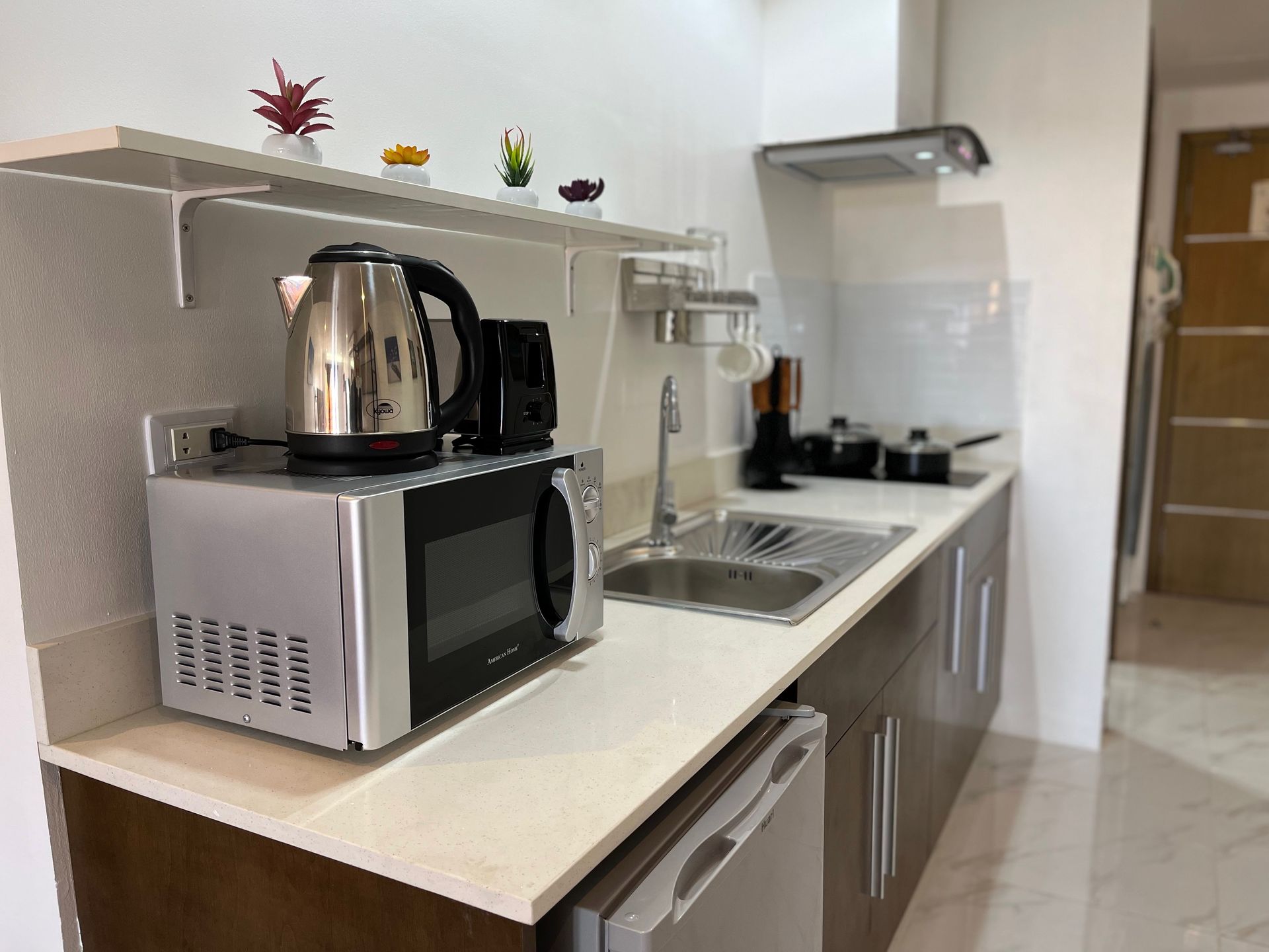 A kitchen with a microwave , sink , and dishwasher.