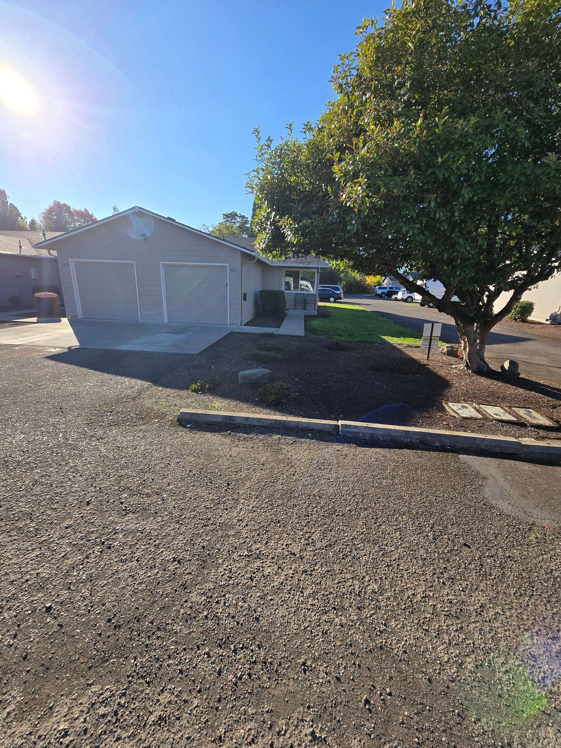 Jackson Duplexes in Albany Oregon – garage exterior with tree. 