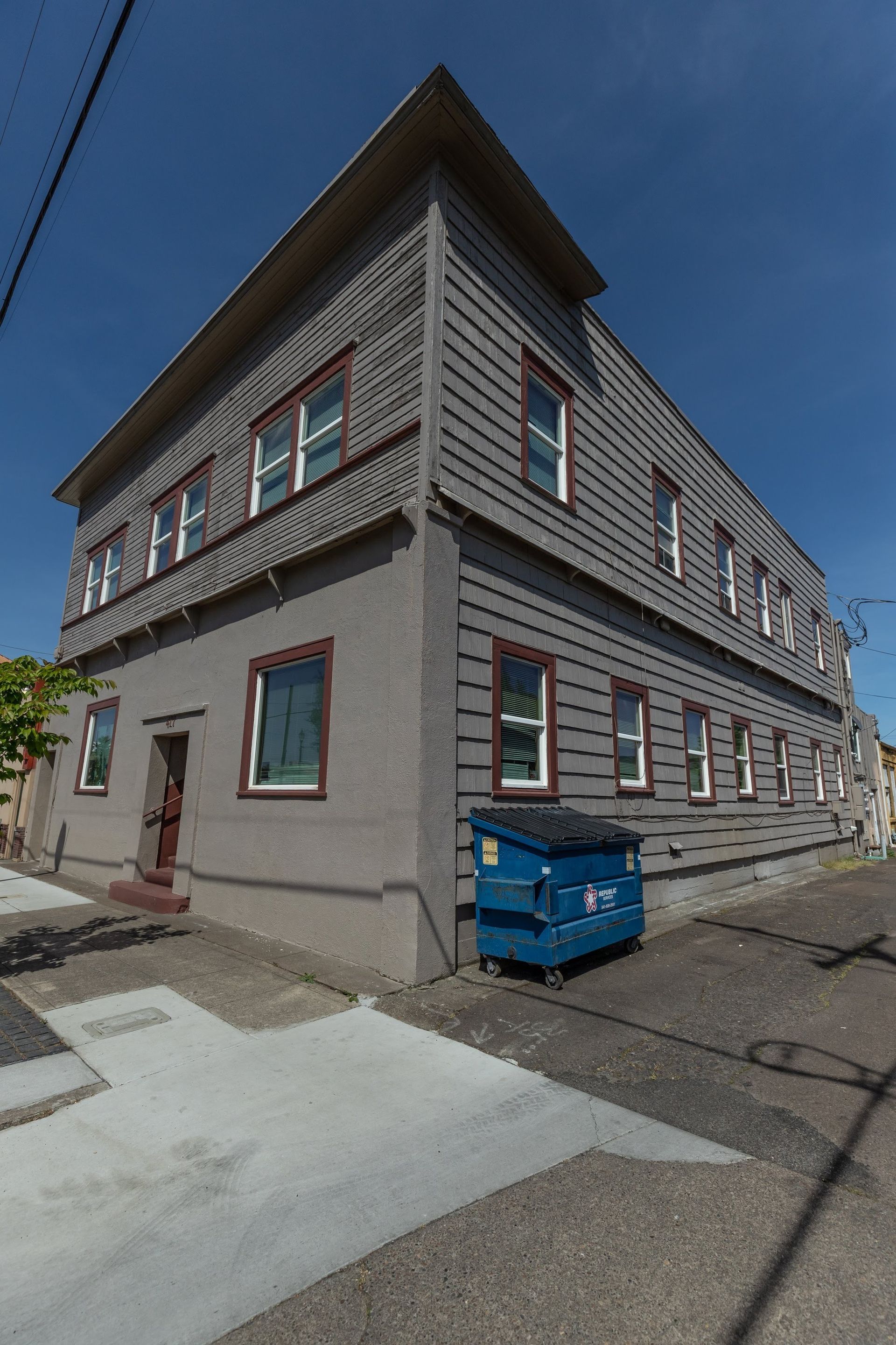 Armory Apartments in downtown Albany Oregon – gray building exterior upper floor and roof.
