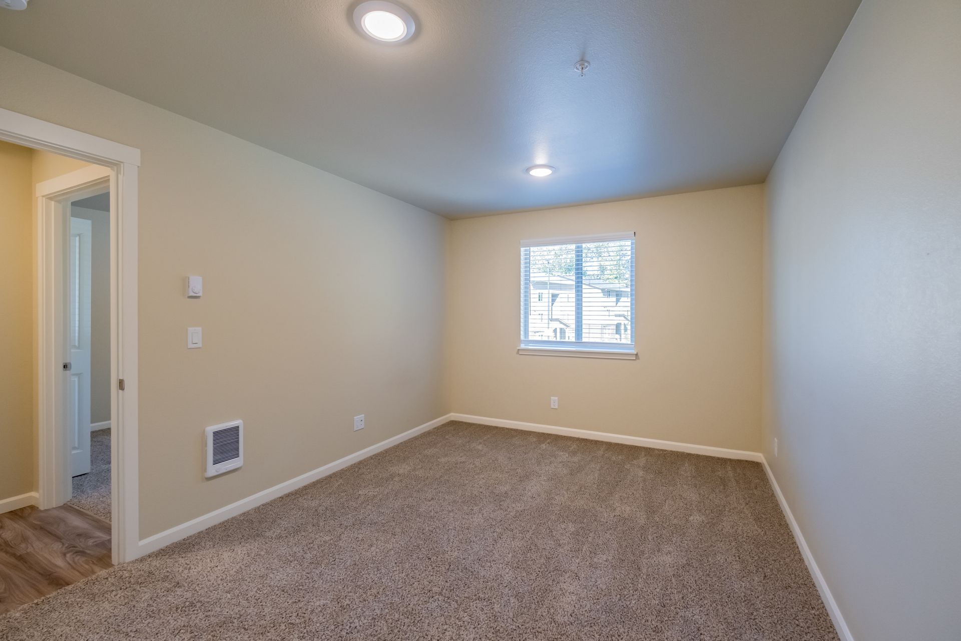 Harmona Heights Apartment community in South Salem Oregon, two-bedroom two-bathroom – master bedroom door and window.