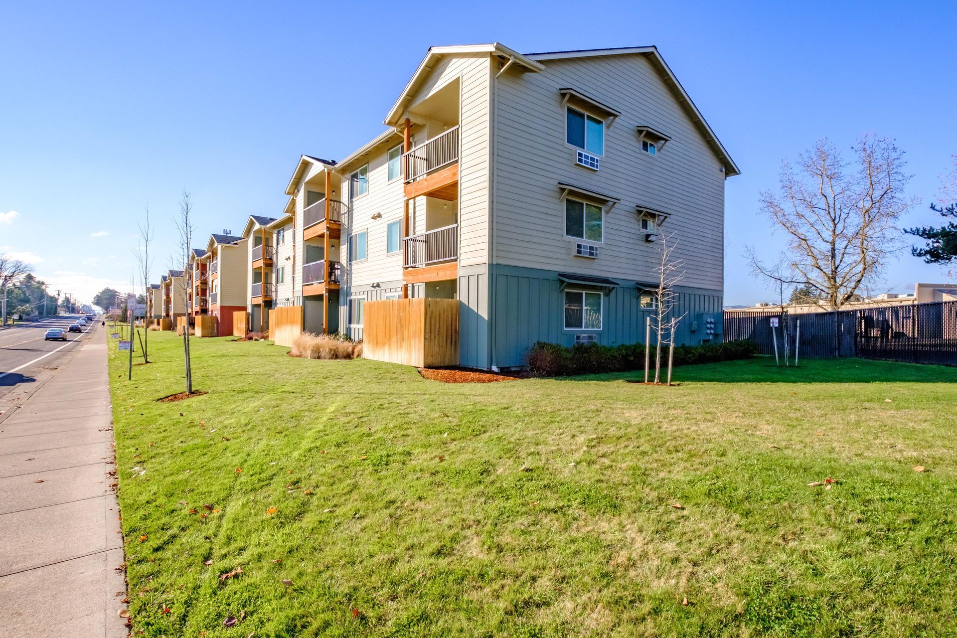 Lafayette Place Apartments in McMinnville, Oregon, near Linfield University – apartment home community building and lawn.