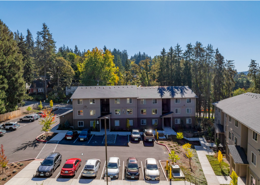 Harmona Heights Apartment community – exterior partial aerial view of apartment community from property rear and parking lot.