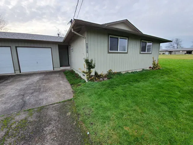 Amanda Lane Duplexes in Millersburg Oregon – gray duplex home, garage and lawn.