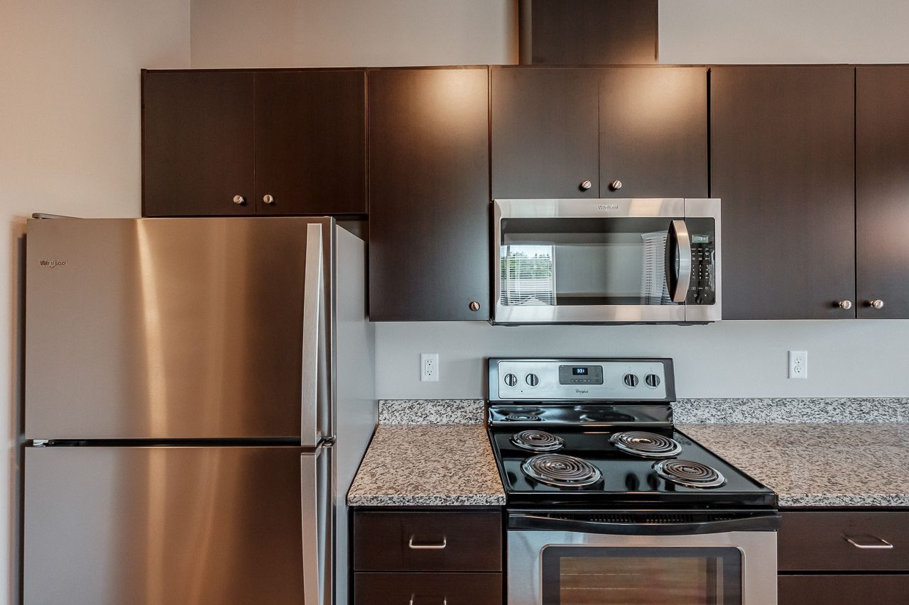 Hickory Hollow Apartments in North Albany OR, two-bedroom two-bathroom – kitchen, refrigerator, stove, microwave, cabinetry.